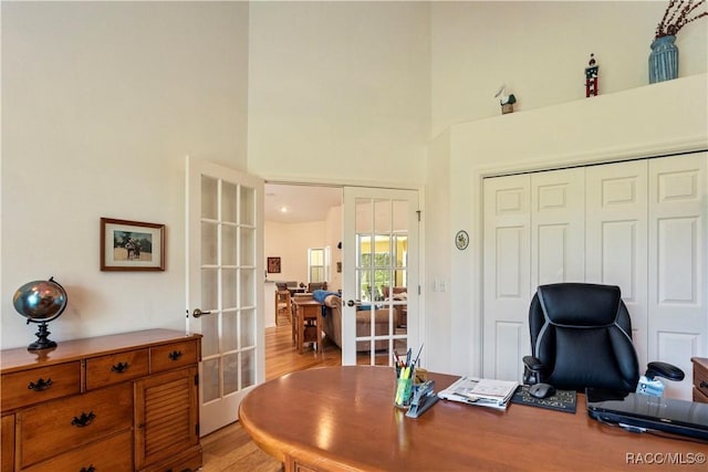 5799 N Oakmont Dr, Beverly Hills, FL 34465 - office with french doors, light wood-style floors, and a towering ceiling
