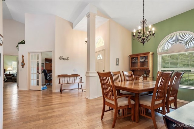5799 N Oakmont Dr, Beverly Hills, FL 34465 - dining room with decorative columns, light wood finished floors, high vaulted ceiling, french doors, and a chandelier