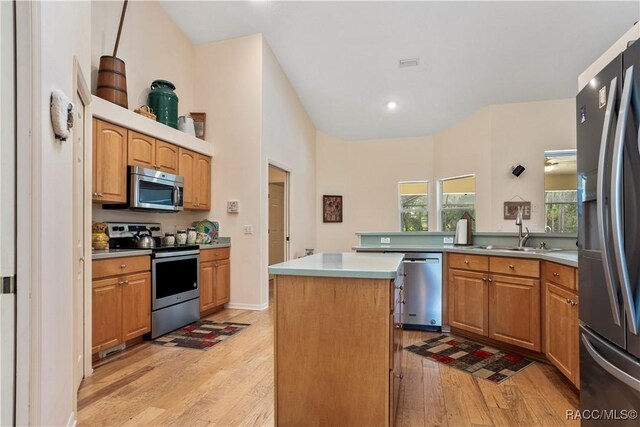 5799 N Oakmont Dr, Beverly Hills, FL 34465 - kitchen with appliances with stainless steel finishes, light wood finished floors, a center island, light countertops, and recessed lighting