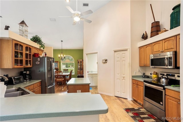 5799 N Oakmont Dr, Beverly Hills, FL 34465 - kitchen featuring appliances with stainless steel finishes, light wood-style floors, ceiling fan, a chandelier, and glass insert cabinets