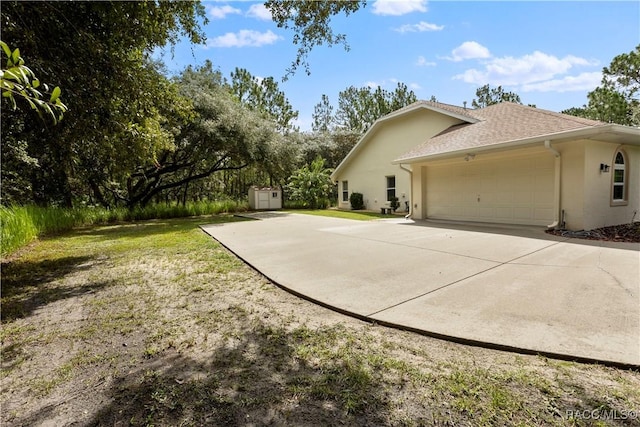 5799 N Oakmont Dr, Beverly Hills, FL 34465 - view of property exterior featuring stucco siding, a garage, a shed, and concrete driveway