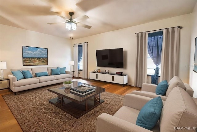 living room featuring ceiling fan and light wood-type flooring