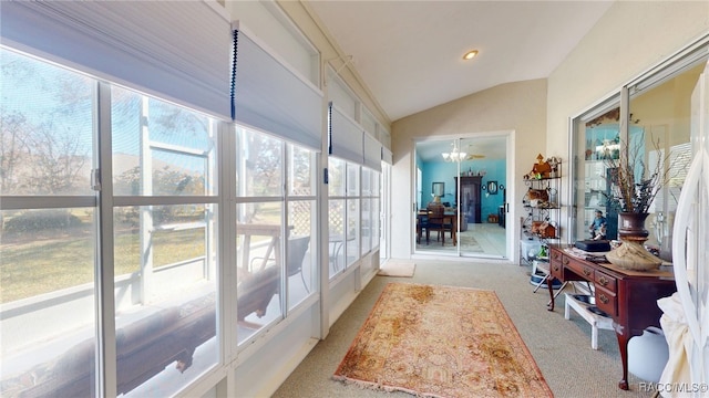 hall featuring lofted ceiling, recessed lighting, light colored carpet, and a notable chandelier