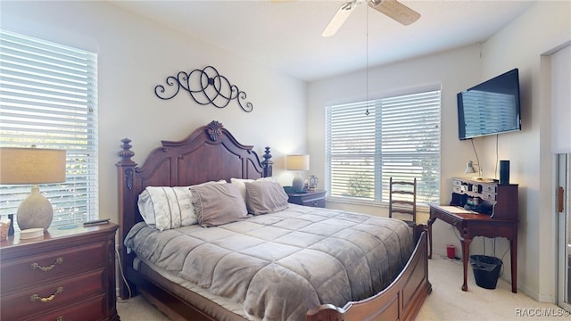 bedroom featuring a ceiling fan and light colored carpet