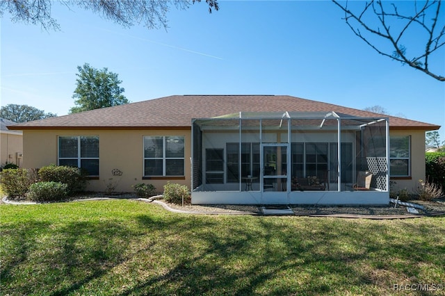 back of property featuring glass enclosure, a lawn, and stucco siding