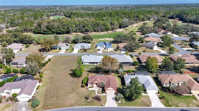 birds eye view of property featuring a residential view and a wooded view