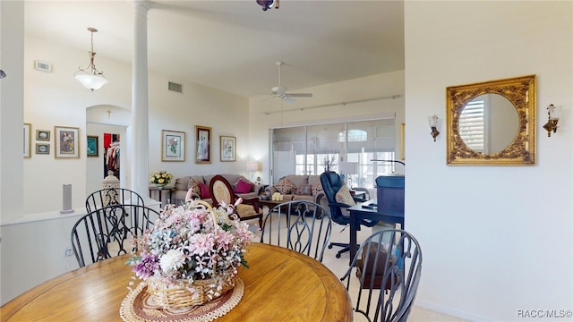 dining area featuring a ceiling fan, arched walkways, and visible vents