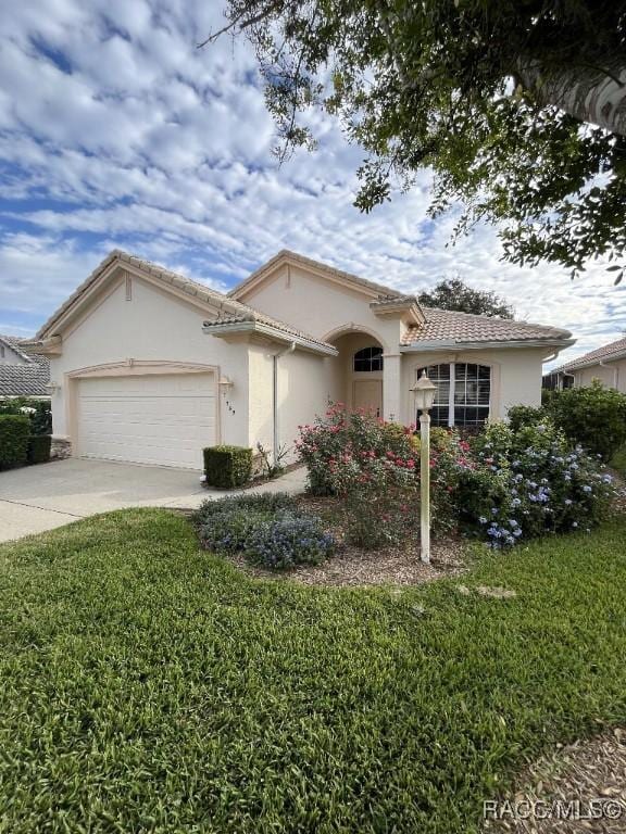 view of front of house with a front yard and a garage