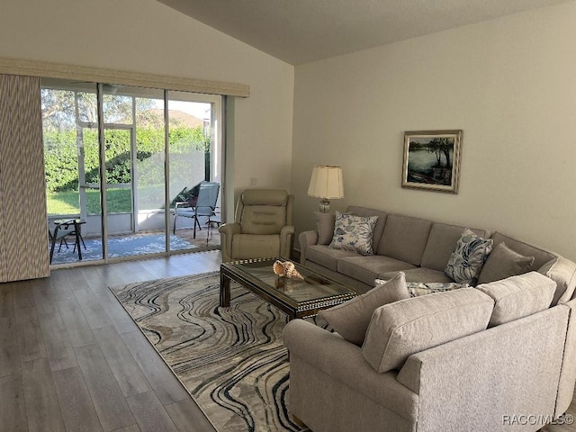 living room featuring hardwood / wood-style flooring and vaulted ceiling