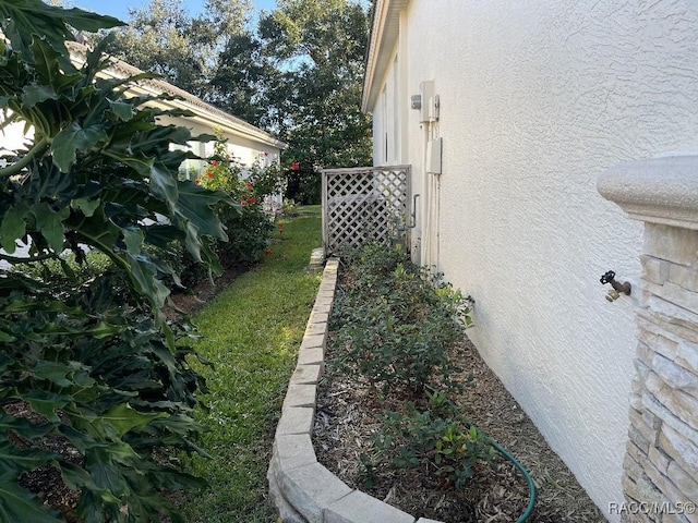 view of side of property with a yard