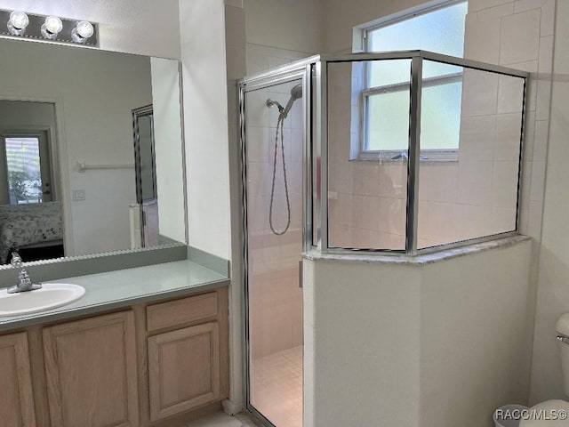 bathroom featuring walk in shower, vanity, and toilet