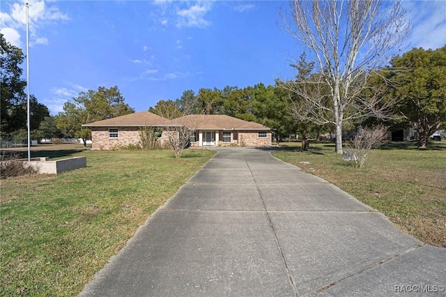 ranch-style home featuring a front yard