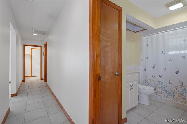 corridor featuring light tile patterned floors