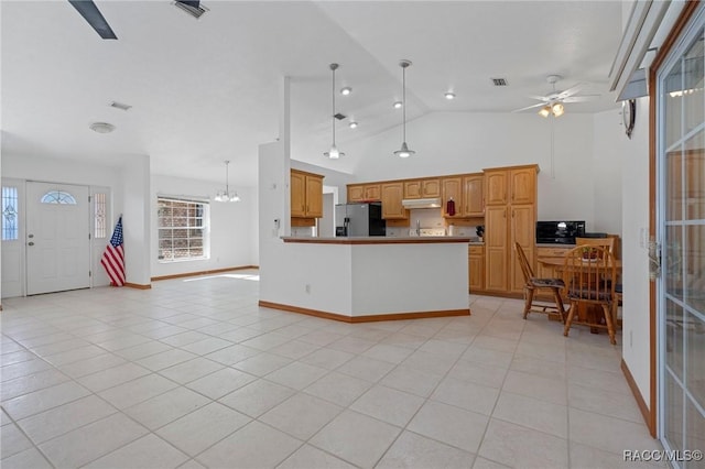 kitchen featuring pendant lighting, ceiling fan with notable chandelier, stainless steel fridge, and light tile patterned floors