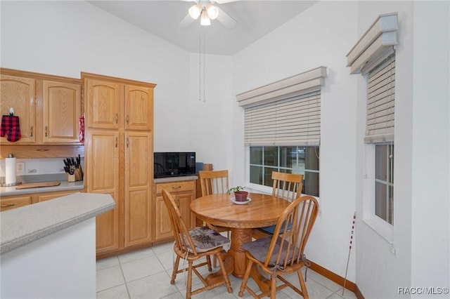 tiled dining area featuring ceiling fan