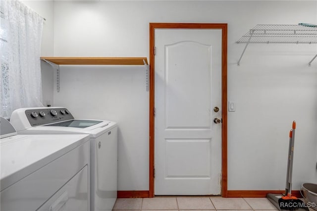 laundry room featuring independent washer and dryer and light tile patterned floors