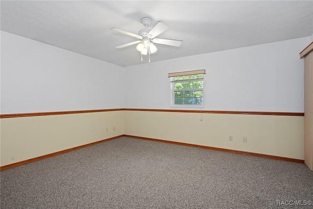 unfurnished room featuring ceiling fan and carpet