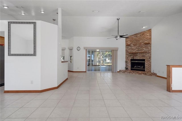 unfurnished living room featuring ceiling fan, light tile patterned floors, lofted ceiling, and a brick fireplace