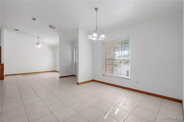 empty room featuring light tile patterned floors and ceiling fan with notable chandelier