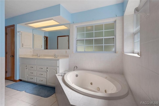 bathroom with vanity, tile patterned floors, and tiled tub