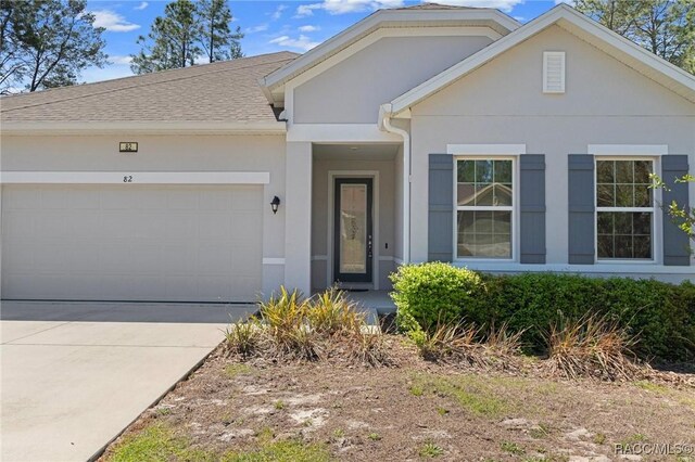 single story home with a front yard and a garage