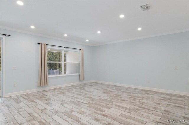 living room with crown molding and light hardwood / wood-style flooring