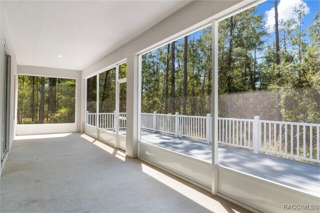 back of house featuring a sunroom, a yard, and a deck