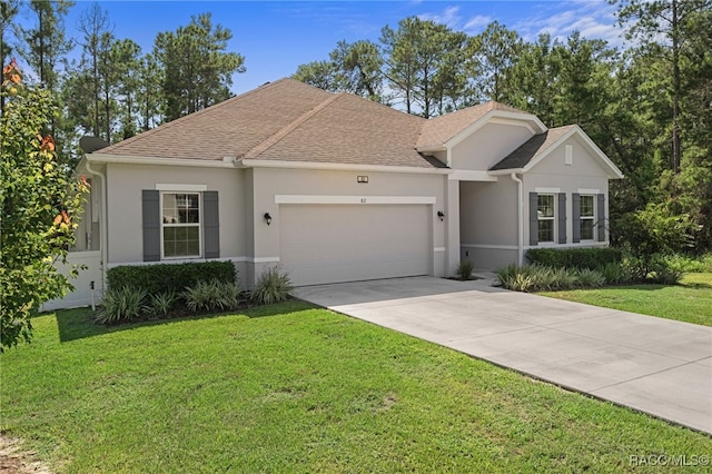 ranch-style house featuring a front yard and a garage