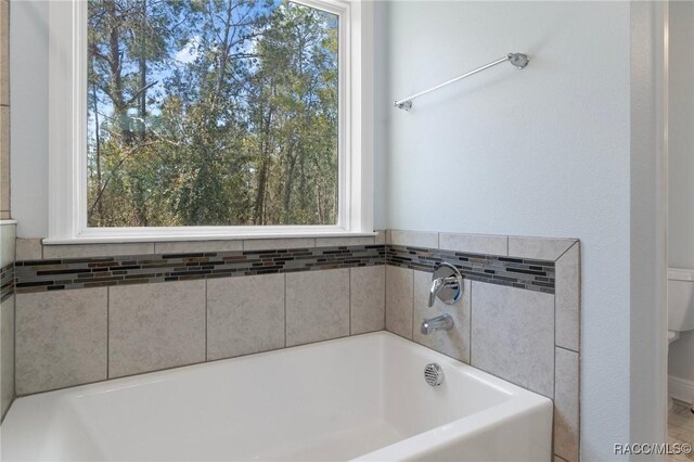 full bathroom with shower / bath combo with shower curtain, vanity, and toilet