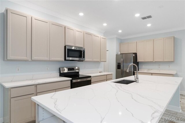 kitchen with sink, light stone countertops, light wood-type flooring, appliances with stainless steel finishes, and ornamental molding