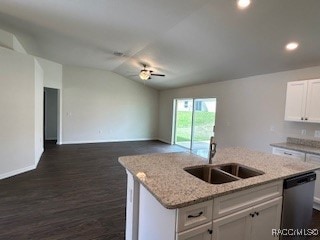 kitchen with stainless steel dishwasher, sink, white cabinetry, lofted ceiling, and an island with sink