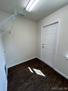 spare room with dark wood-type flooring