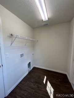 clothes washing area featuring washer hookup, dark hardwood / wood-style flooring, and a textured ceiling