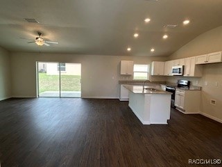 kitchen with stainless steel appliances, white cabinetry, dark hardwood / wood-style floors, and a healthy amount of sunlight