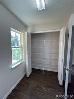 unfurnished bedroom with dark wood-type flooring