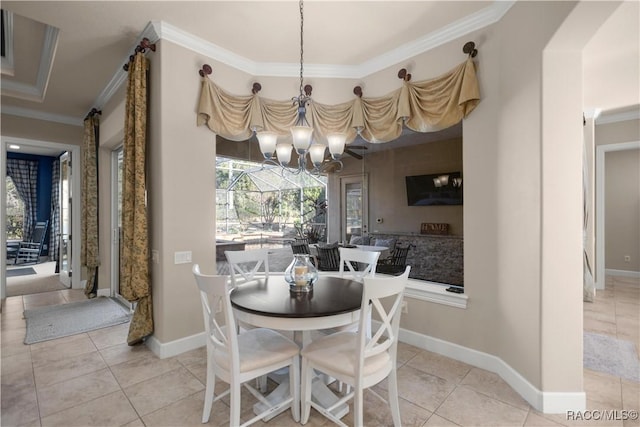 dining space with light tile patterned floors, a notable chandelier, and ornamental molding