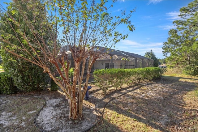 view of yard featuring glass enclosure