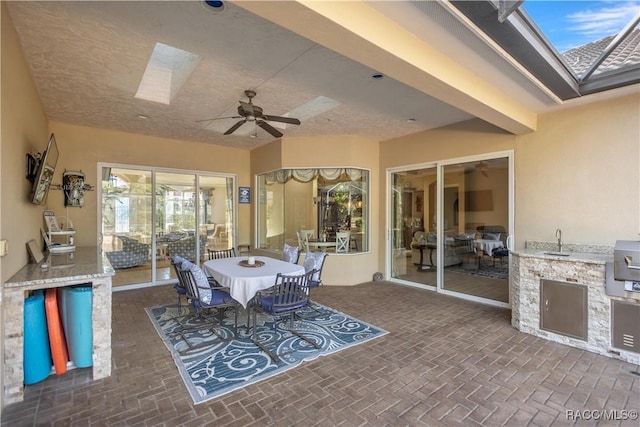 interior space with a skylight, ceiling fan, and sink