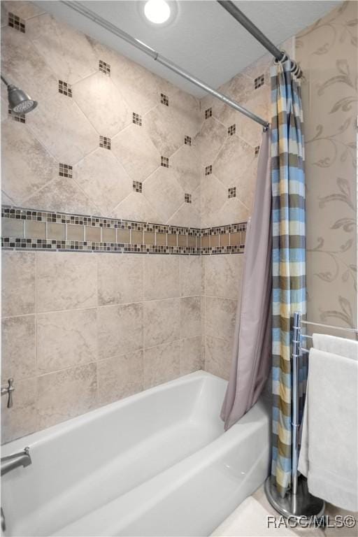 bathroom with shower / tub combo with curtain