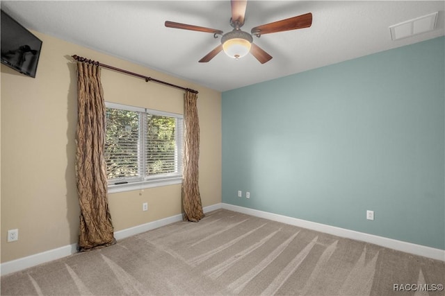 carpeted spare room with ceiling fan