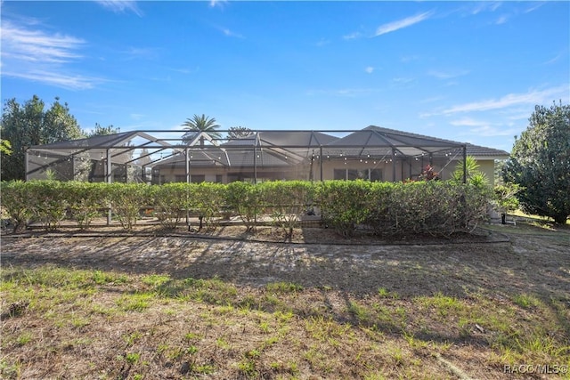 view of yard featuring glass enclosure