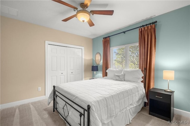 bedroom with light carpet, a closet, and ceiling fan