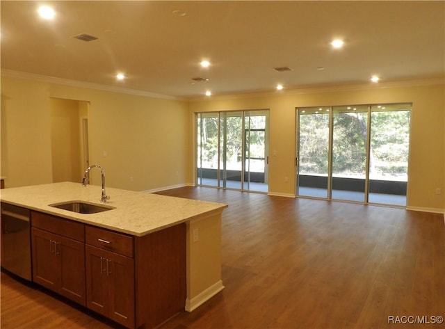 kitchen with sink, light stone counters, dark hardwood / wood-style flooring, black dishwasher, and an island with sink