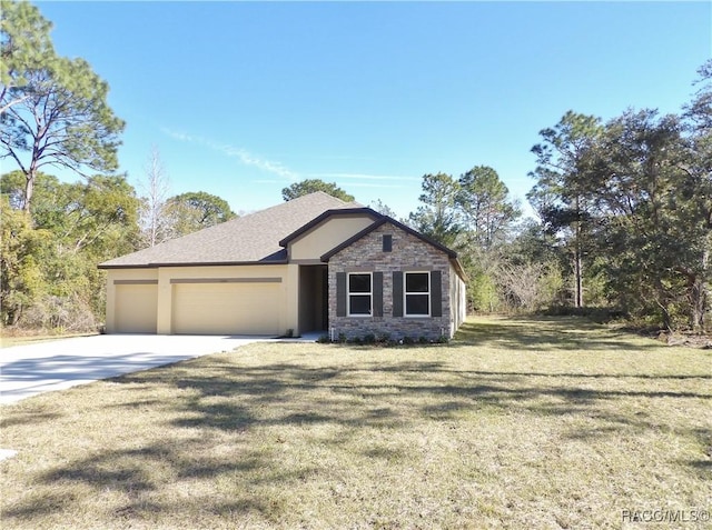 view of front of property featuring a garage and a front yard