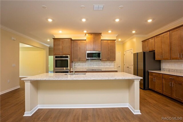 kitchen with sink, backsplash, light stone counters, stainless steel appliances, and crown molding