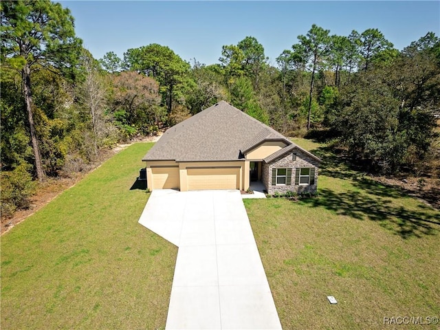 view of front facade featuring stone siding, a front lawn, concrete driveway, and an attached garage