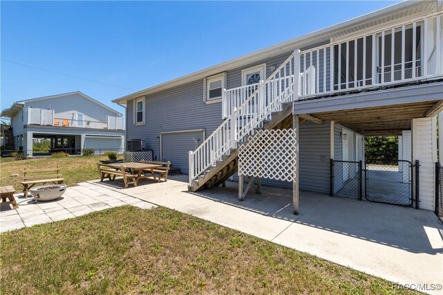 9 Flagler Dr, Palm Coast, FL 32137 - rear view of property featuring an outdoor fire pit, stairs, a patio, a gate, and a wooden deck