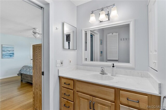 9 Flagler Dr, Palm Coast, FL 32137 - bathroom featuring ensuite bathroom, ceiling fan, vanity, and wood finished floors