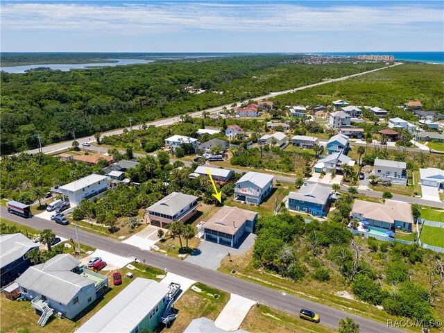 9 Flagler Dr, Palm Coast, FL 32137 - aerial view of residential area featuring a nearby body of water and a heavily wooded area