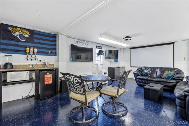 9 Flagler Dr, Palm Coast, FL 32137 - living room featuring a dry bar and speckle patterned floor